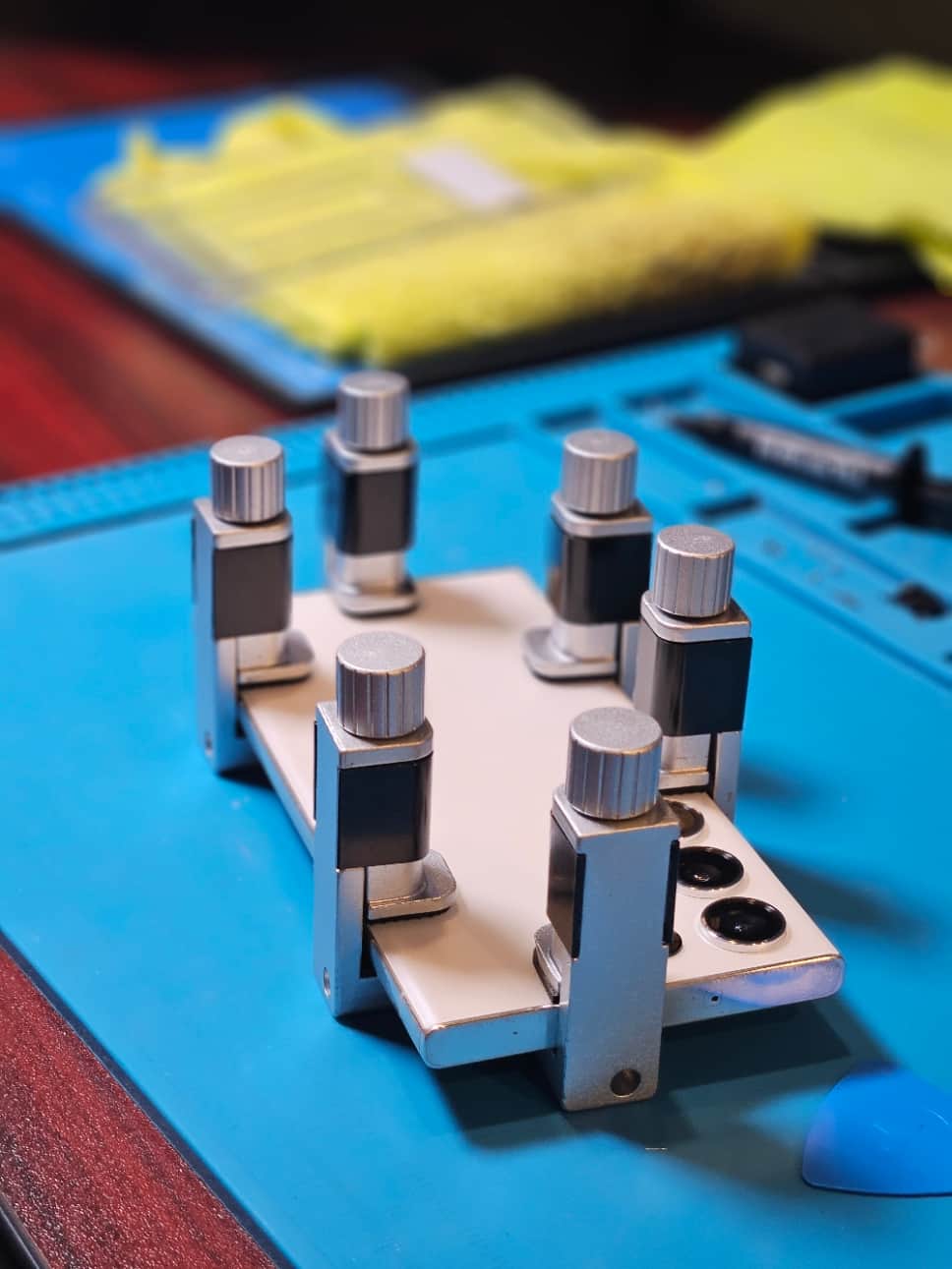 Smartphone secured with repair clamps on the workbench